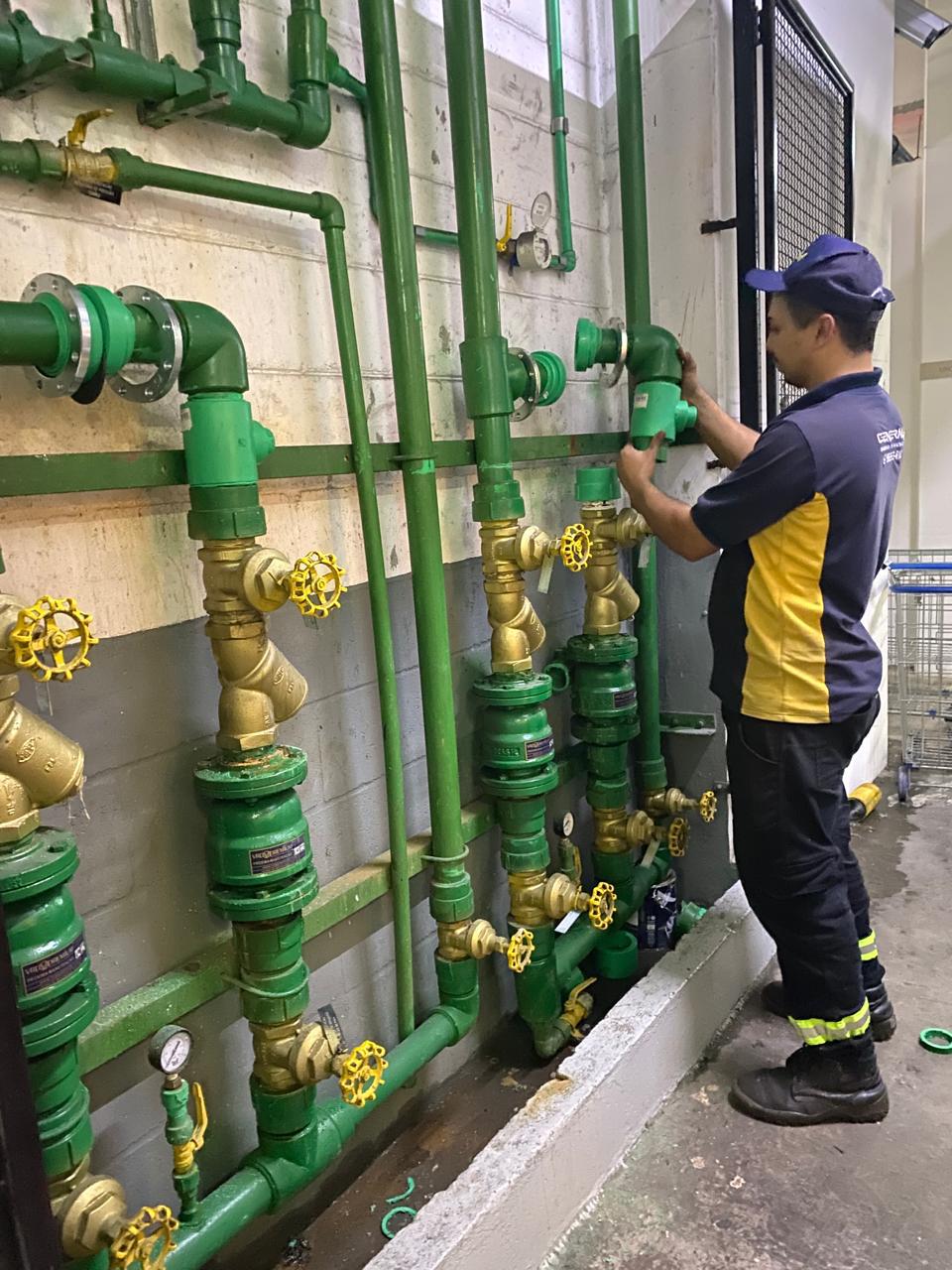Técnico da General operando registros em um barrilete de tubulação hidráulica